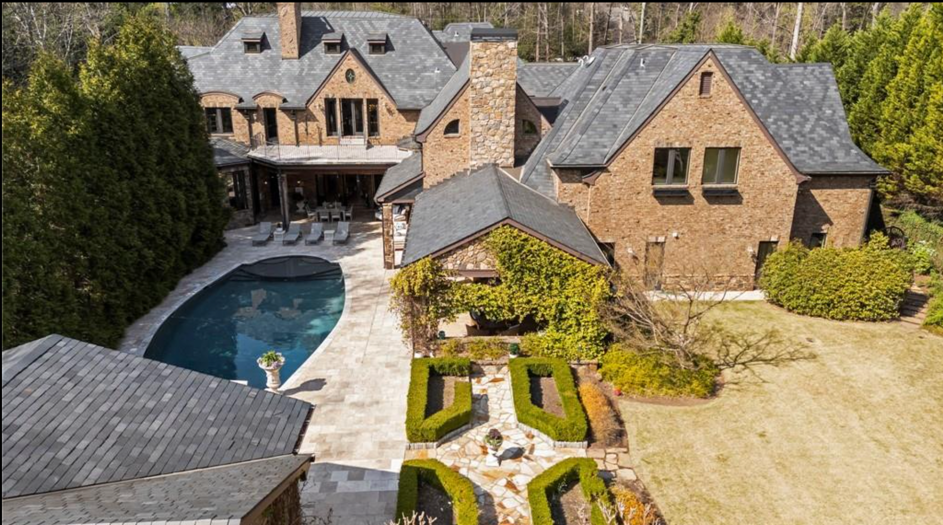 Rear aerial view of the cleaned Mt. Paran estate, slate roof, brick exterior, pool and grounds