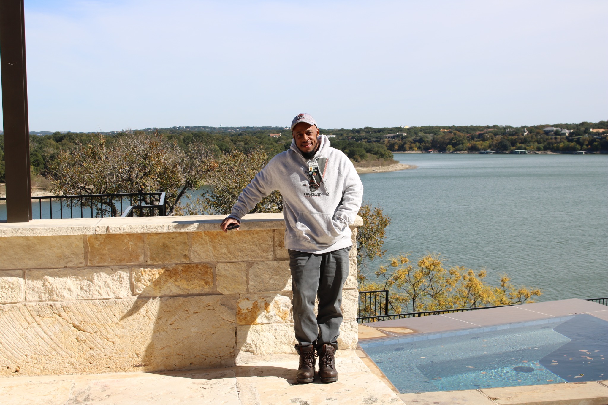 Shawn Daniels wearing Unique Power Wash branding at a lakefront property